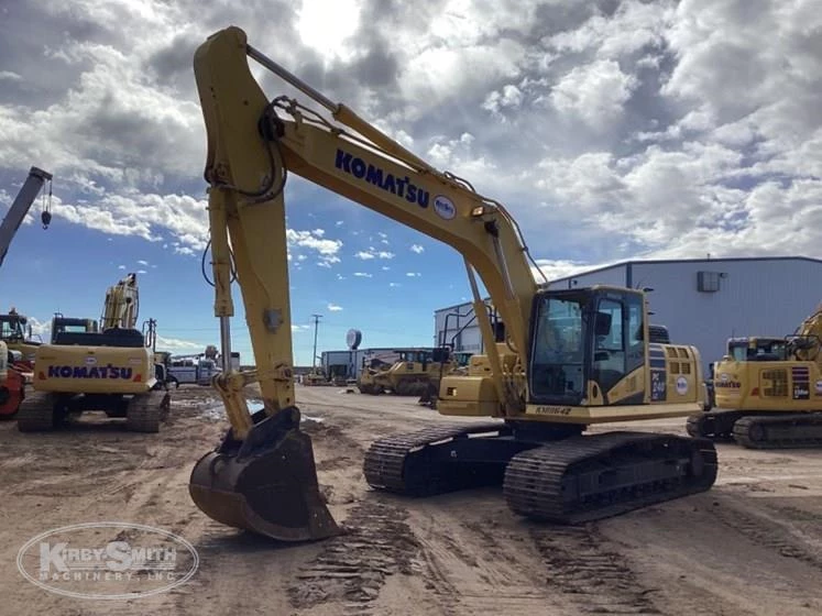 Used Komatsu under cloudy sky